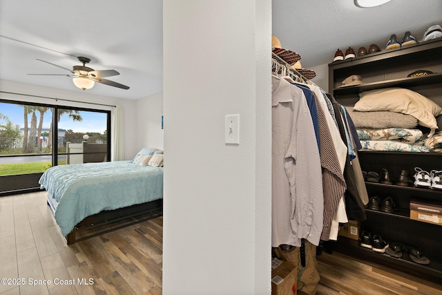 bedroom featuring ceiling fan, access to outside, and wood-type flooring