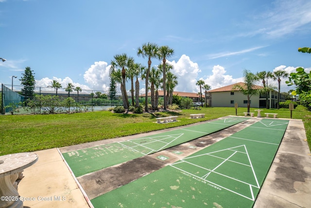 view of property's community featuring a water view and a lawn