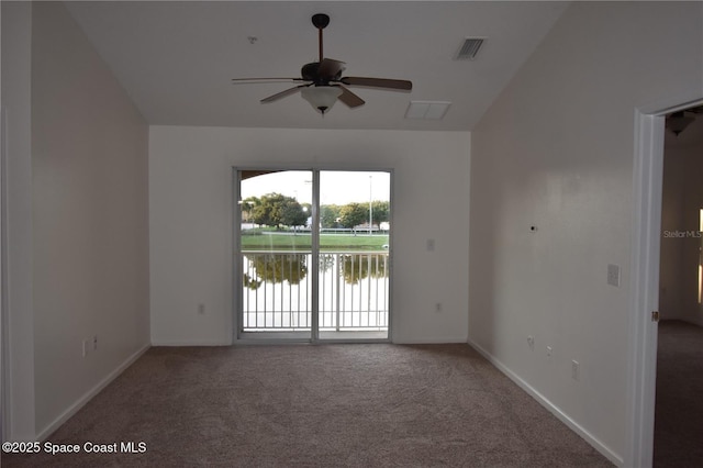 carpeted spare room featuring a water view and ceiling fan