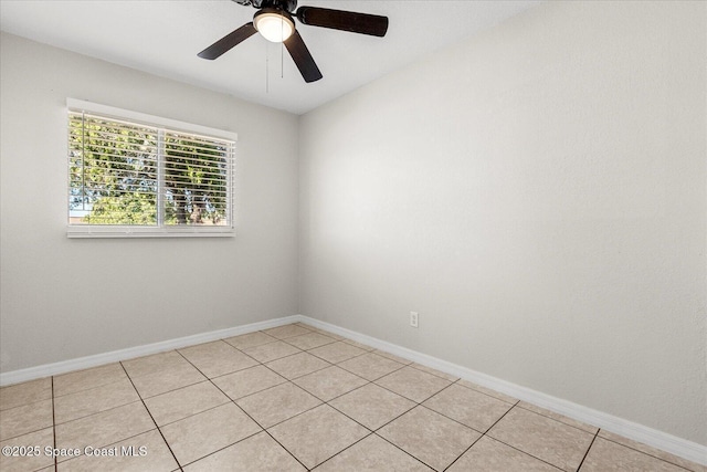 tiled spare room with ceiling fan