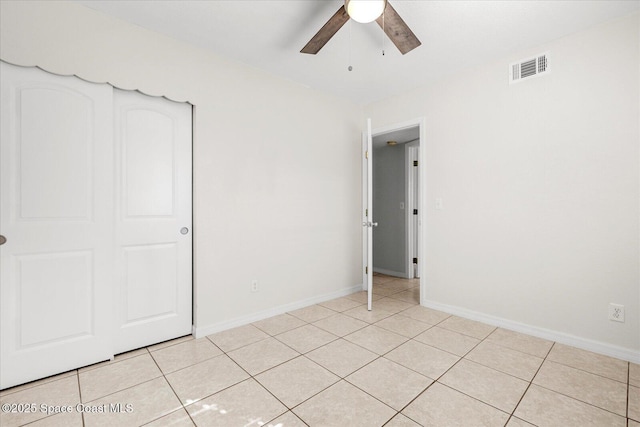 unfurnished bedroom featuring ceiling fan and light tile patterned flooring