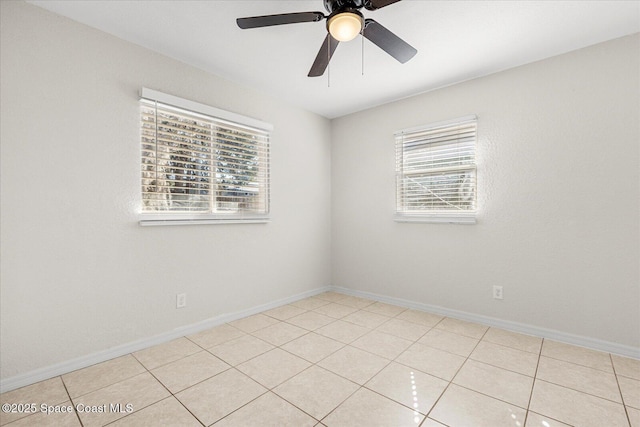 tiled spare room featuring ceiling fan