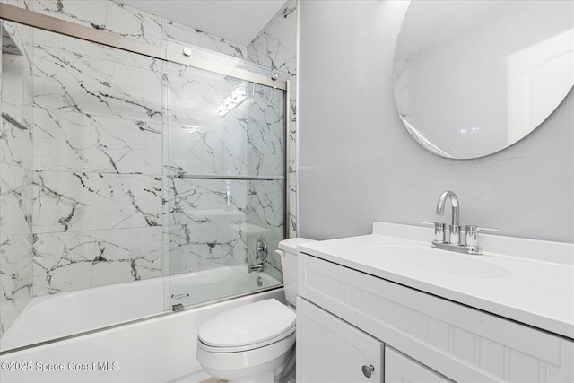 full bathroom featuring toilet, vanity, and shower / bath combination with glass door