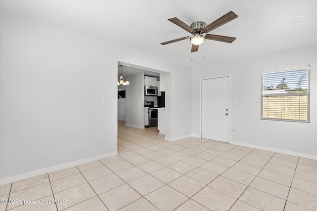 tiled spare room with ceiling fan and a textured ceiling