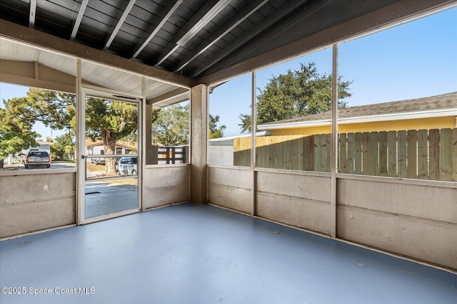 unfurnished sunroom with vaulted ceiling