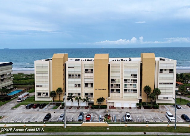 drone / aerial view with a view of the beach and a water view