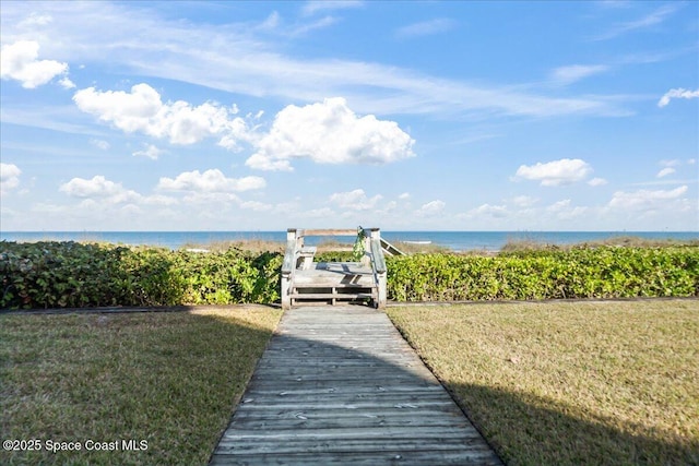 view of property's community featuring a water view and a yard