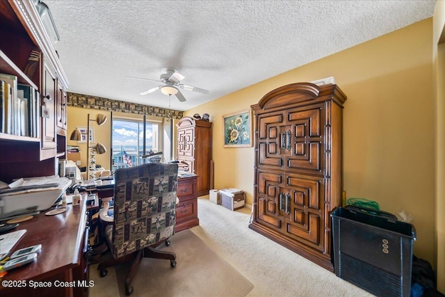 office with light carpet, a textured ceiling, and ceiling fan