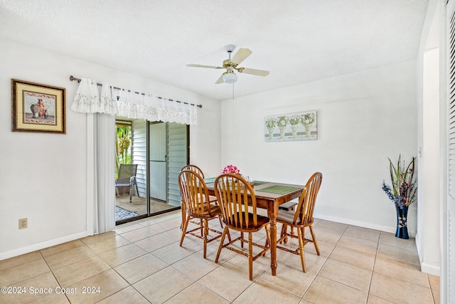 dining space featuring a textured ceiling, ceiling fan, and light tile patterned flooring