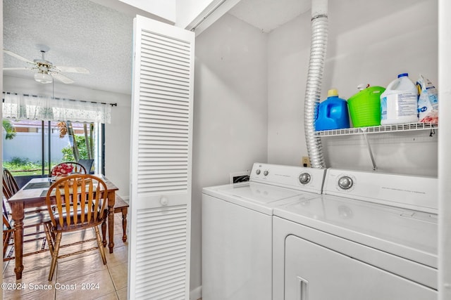 clothes washing area with ceiling fan, light tile patterned floors, a textured ceiling, and independent washer and dryer