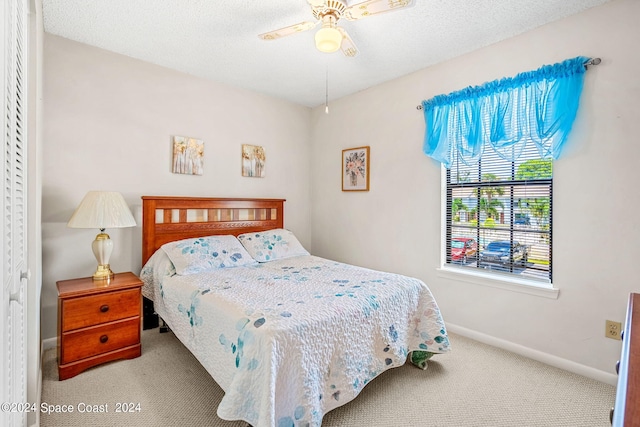 carpeted bedroom featuring a closet and ceiling fan