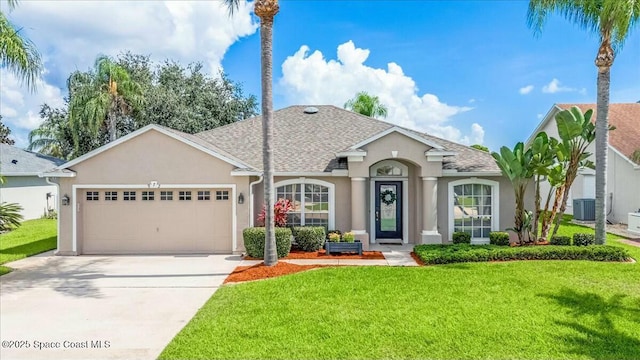 ranch-style home with a garage, a front lawn, and central air condition unit