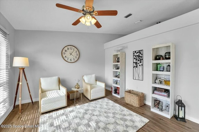 living area with vaulted ceiling, dark wood-type flooring, and ceiling fan