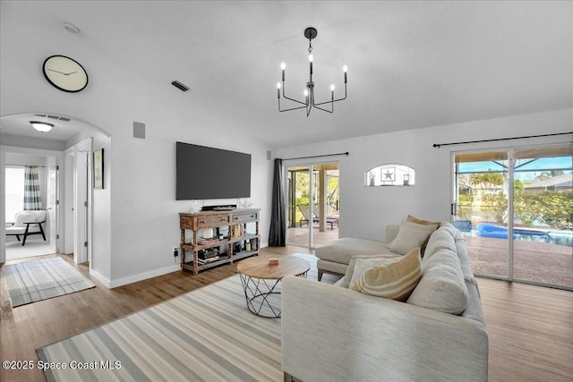 living room with wood-type flooring and a chandelier