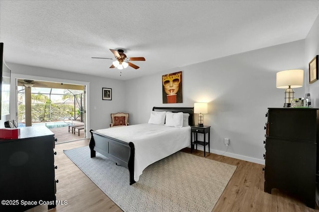 bedroom featuring access to exterior, light hardwood / wood-style floors, a textured ceiling, and ceiling fan