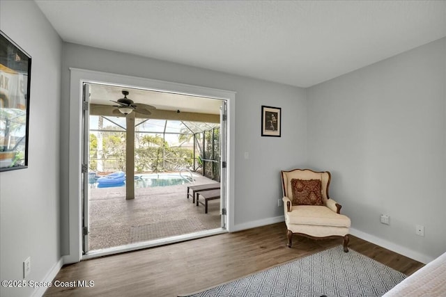 sitting room with wood-type flooring and ceiling fan