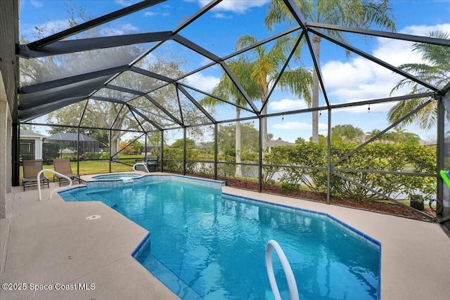 view of swimming pool with an in ground hot tub, a patio, and glass enclosure