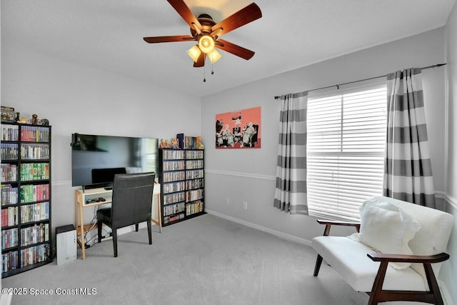 carpeted office space with ceiling fan