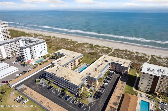 bird's eye view featuring a water view and a view of the beach