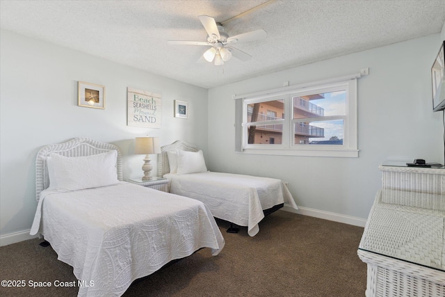 carpeted bedroom with ceiling fan and a textured ceiling