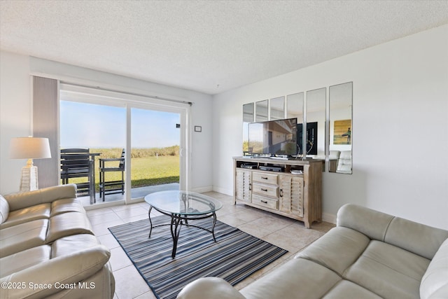 living room featuring light tile patterned flooring and a textured ceiling