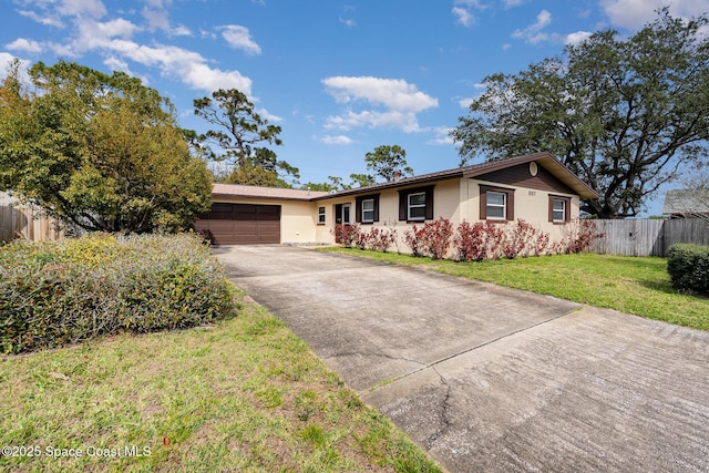 ranch-style house featuring driveway, a front lawn, an attached garage, and fence