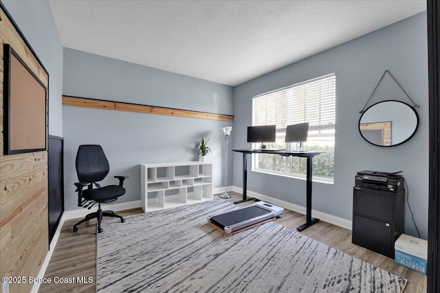 office area featuring a textured ceiling and light wood-type flooring