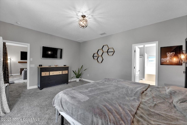 bedroom featuring connected bathroom, light colored carpet, and a textured ceiling