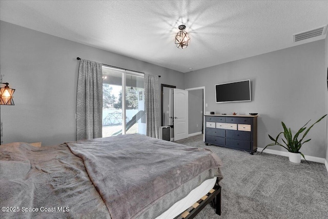 carpeted bedroom featuring access to outside and a textured ceiling