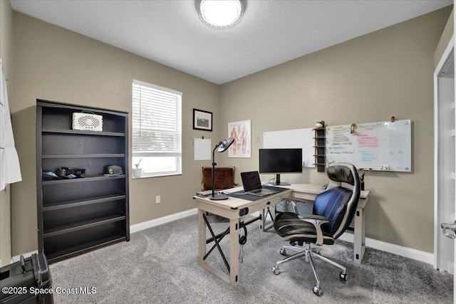 office area featuring a textured ceiling and carpet flooring