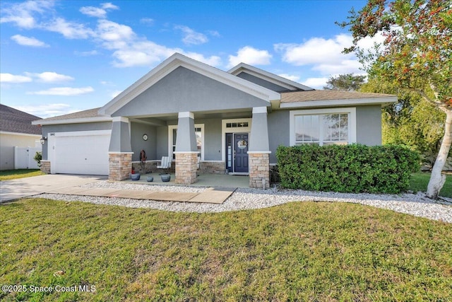 craftsman-style home featuring a garage, covered porch, and a front lawn