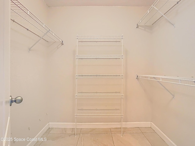 spacious closet with tile patterned floors