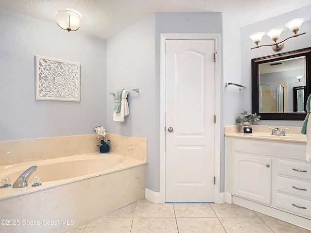 bathroom featuring tile patterned flooring, vanity, independent shower and bath, and a textured ceiling