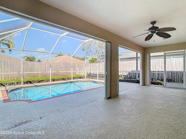 view of pool featuring a lanai, a patio area, and ceiling fan