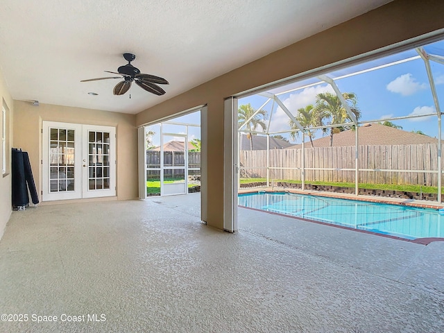 view of pool with a patio, a lanai, french doors, and ceiling fan