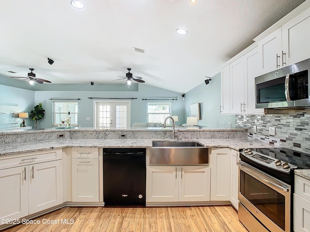 kitchen with white cabinetry, sink, lofted ceiling, and appliances with stainless steel finishes