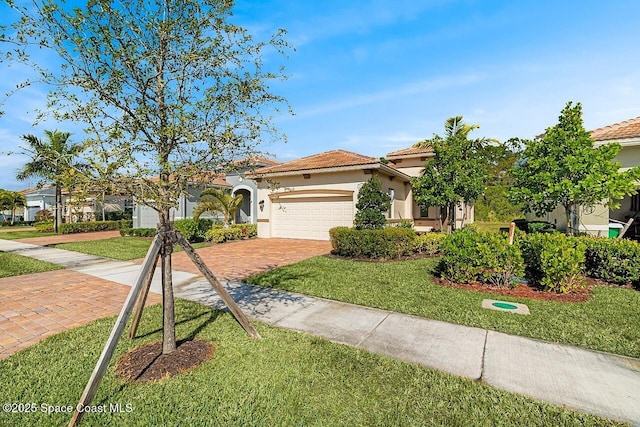 mediterranean / spanish house featuring a garage and a front yard