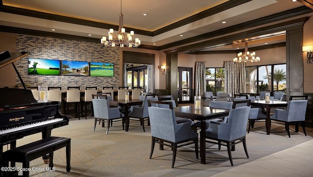 dining space featuring crown molding, plenty of natural light, and a notable chandelier
