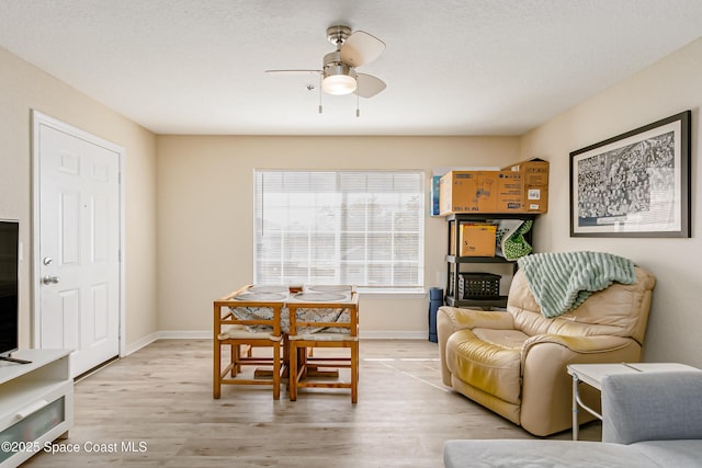 living room featuring ceiling fan and light wood-type flooring