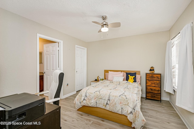 bedroom with multiple windows, ceiling fan, and light wood-type flooring