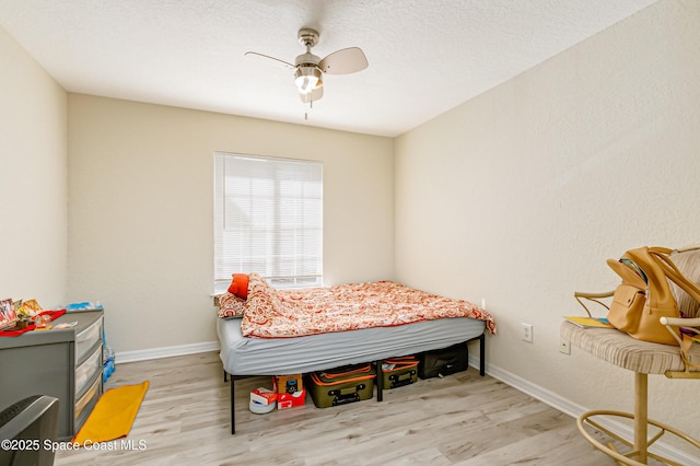 bedroom with ceiling fan and light hardwood / wood-style floors