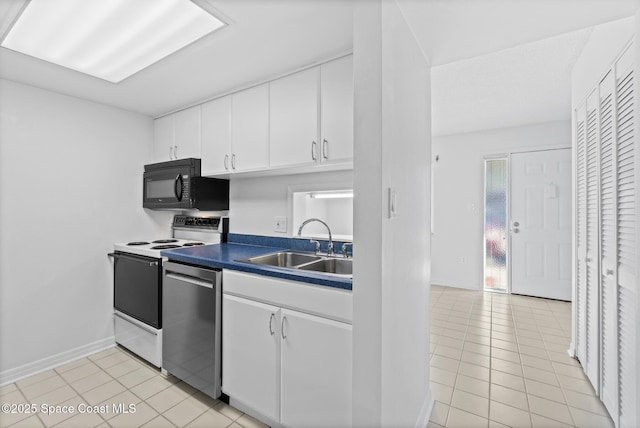 kitchen featuring sink, electric range oven, light tile patterned floors, dishwasher, and white cabinets