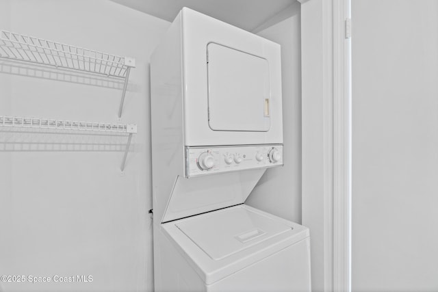 laundry room with stacked washer and dryer