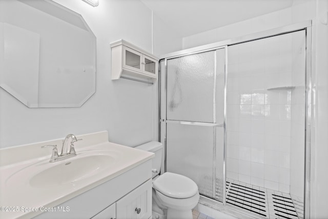 bathroom with walk in shower, vanity, and toilet