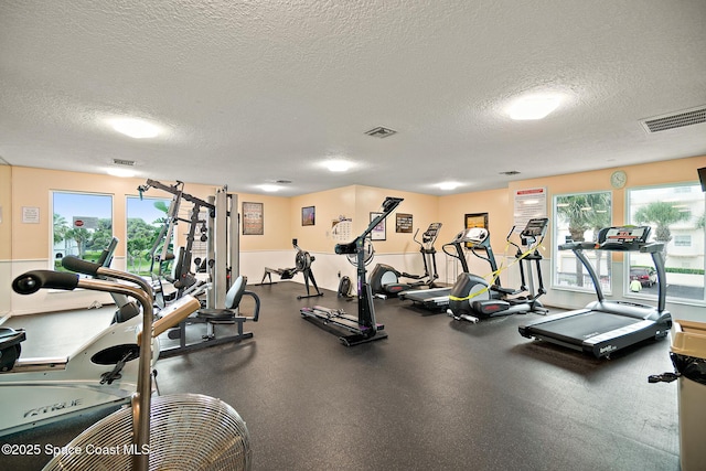 exercise room featuring a textured ceiling