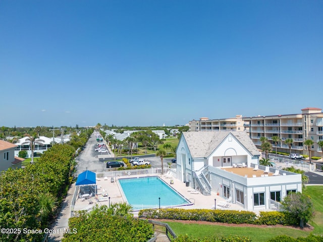 exterior space with a community pool and a patio area