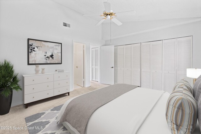 143 Seaport Blvd Unit 20, Cape Canaveral, FL 32920 - bedroom with light colored carpet, high vaulted ceiling, and ceiling fan