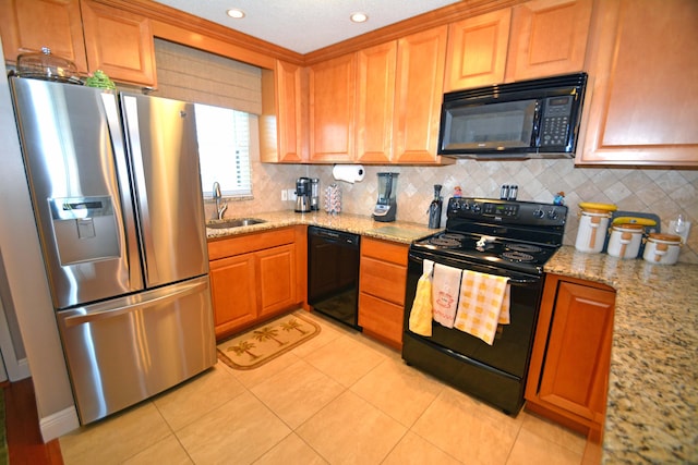 kitchen featuring sink, light tile patterned floors, backsplash, black appliances, and light stone countertops