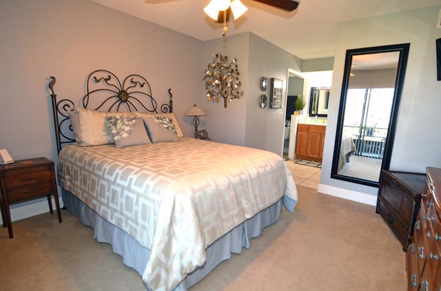 carpeted bedroom with ensuite bath and ceiling fan