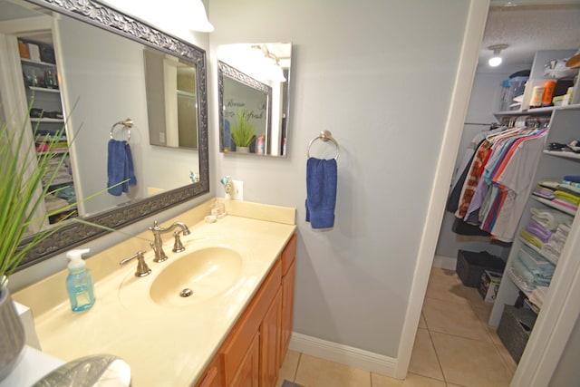 bathroom with vanity, tile patterned flooring, and a textured ceiling